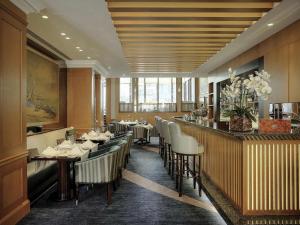 a restaurant with tables and chairs and a bar at Sofitel Beirut Le Gabriel in Beirut