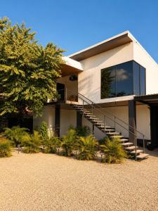 a house with a staircase in front of it at Villas Na-tiva Guanacaste in Plazuela