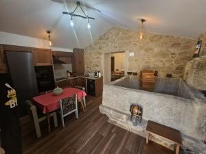 a kitchen and dining room with a large tub in a room at El Lagar de Mailusa in Sayar +8 photos