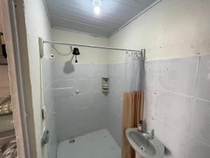a bathroom with a shower and a toilet and a sink at Colombia Hostel in Porto Seguro +21 photos