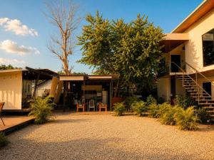 a house with a porch and a patio at Villas Na-tiva Guanacaste in Plazuela +35 photos