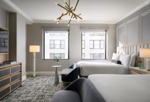 a hotel room with two beds and a couch at InterContinental Indianapolis by IHG in Indianapolis +108 photos