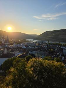 a view of a city with the sunset in the background at RheinStay Bingen in Bingen am Rhein
