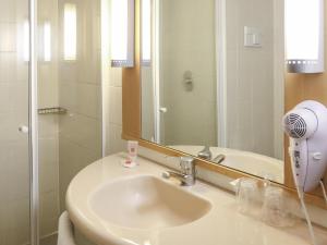 a bathroom with a sink and a mirror at ibis Buenos Aires Congreso in Buenos Aires