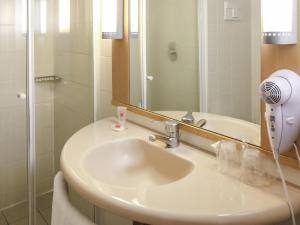 a bathroom with a sink and a mirror at ibis Buenos Aires Congreso in Buenos Aires +54 photos