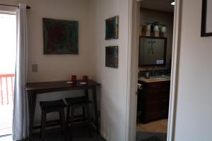 a bathroom with a desk and a sink and a mirror at Harvest House Inn in Springdale