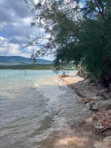 a beach with people swimming in the water at Mobile Home ABC in Donji Karin