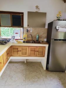 a kitchen with a sink and a refrigerator at Serena Grau in San Antero +13 photos