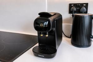 a coffee maker sitting on top of a desk at City Penthouse - Roof Terrace & Free Parking in Beeston Hill +36 photos