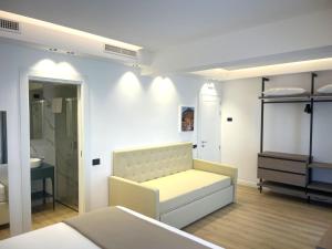 a white room with a bed and a sink at Hotel La Giara in Cefalù +110 photos