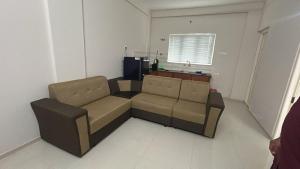 a living room with a couch and a window at Stay near to temple 240m in Guruvāyūr