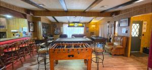 a room with a table and chairs and a bar at 4 River Lake Sea in Parker