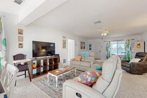 a living room with a couch and a tv at 4 Mi to Beach! Lake-View Florida Family Retreat in JFK Medical Center Incorporated Heliport