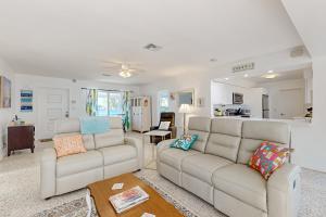 a living room with two couches and a kitchen at 4 Mi to Beach! Lake-View Florida Family Retreat in JFK Medical Center Incorporated Heliport