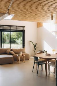 a living room with a couch and a table at Projekt Babia - Domek z jacuzzi in Lipnica Wielka