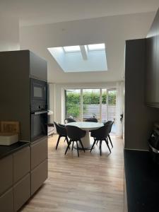 a kitchen and dining room with a table and chairs at Spacious Luxury Villa in Copenhagen in Copenhagen