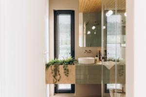 a bathroom with a sink and a mirror at Projekt Babia - Domek z jacuzzi in Lipnica Wielka +37 photos