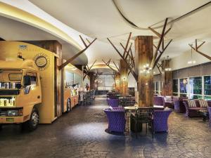 a food truck parked in a restaurant with purple chairs at Mercure Surabaya Grand Mirama in Surabaya