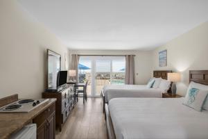 a hotel room with two beds and a balcony at Ocean Surf Resort in Montauk