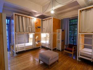 a room with two sets of bunk beds and a chair at Casa Pepe in Mexico City +142 photos