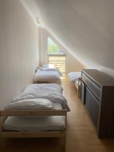 a row of beds in a room with an attic at Apartament Kościuszki in Malbork