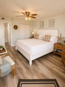 a bedroom with a white bed and a ceiling fan at Ocean Pointe Resorts - Serenity 2308 in Tavernier +197 photos
