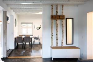 a dining room with white walls and a table with chairs at Fewo zum Ritzli in Ettenheim