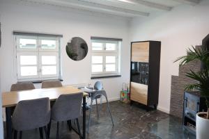 a room with a table and chairs and a bedroom at Fewo zum Ritzli in Ettenheim