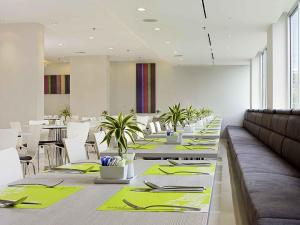 a dining room with tables with green napkins and chairs at ibis Bangkok Sathorn in Bangkok +33 photos