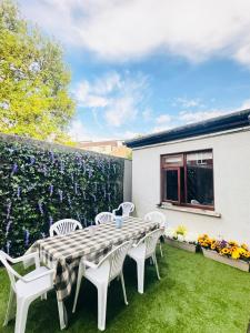 a patio with a table and chairs and a fence at The Ambassador Apartment in Carrick on Shannon +15 photos