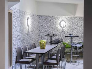 a dining room with a table and chairs at ibis Styles Nice Vieux Port in Nice