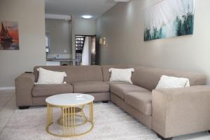 a living room with a couch and a table at Nao's Place in Dorchester Heights 