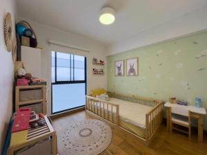 a childs bedroom with a crib and a window at David House 3BR Pent Mira in Lima
