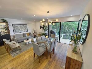a dining room and living room with a table and chairs at David House 3BR Pent Mira in Lima