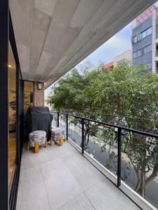 a balcony with a chair and a view of a building at David House 3BR Pent Mira in Lima +1 photo