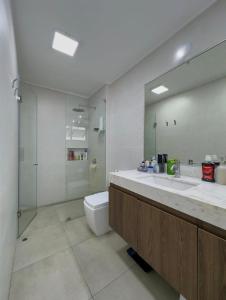 a bathroom with a toilet and a sink and a shower at David House 3BR Pent Mira in Lima