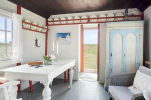 a living room with a white table and a window at 1355-Vestervig-Klitvej-4 in Agger +11 photos