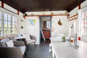 a living room with a white table and chairs at 1355-Vestervig-Klitvej-4 in Agger