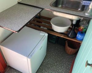 a small kitchen with a sink and a refrigerator at 1355-Vestervig-Klitvej-4 in Agger