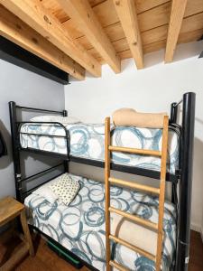 two bunk beds in a room with a wooden ceiling at Metro Hostal Boutique in Mexico City