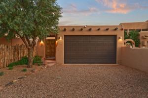 a garage door in front of a house at Restored Adobe Casita Big Views Walk to Plaza in Santa Fe