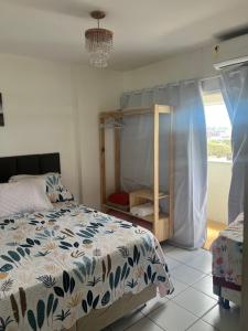 a bedroom with a bed and a window at Apartamento Beira Mar in Maceió