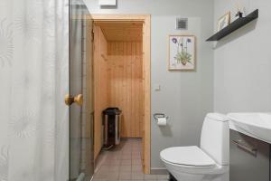a bathroom with a toilet and a wooden door at 7726-Hvide-Sande-Slusen-26 in Hvide Sande +33 photos