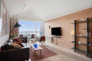 a living room with a couch and a tv at 7726-Hvide-Sande-Slusen-26 in Hvide Sande