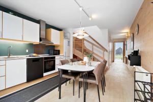 a kitchen and dining room with a table and chairs at 7726-Hvide-Sande-Slusen-26 in Hvide Sande