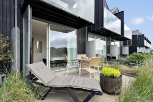a patio with chairs and a table on a house at 7726-Hvide-Sande-Slusen-26 in Hvide Sande