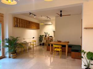 a dining room with a table and chairs in a room at The Habitat By Locomo in Mandrem