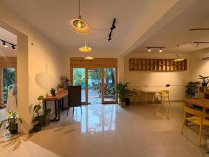 a living room with a table and a dining room at The Habitat By Locomo in Mandrem