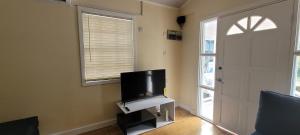 a living room with a flat screen tv and a door at Valley Nest 758 in Castries