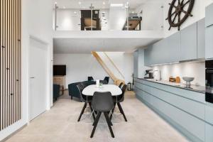 a kitchen and dining room with a table and chairs at 782-Hvide-Sande-Norregade-2-nr-25 in Hvide Sande